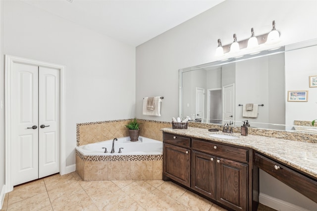 bathroom with vanity, a garden tub, and tile patterned flooring