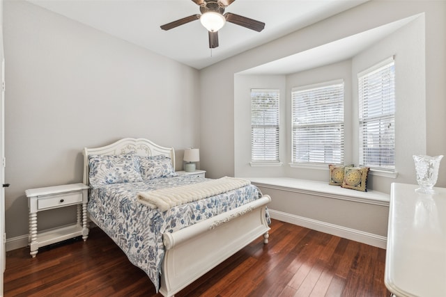 bedroom featuring hardwood / wood-style flooring, a ceiling fan, and baseboards