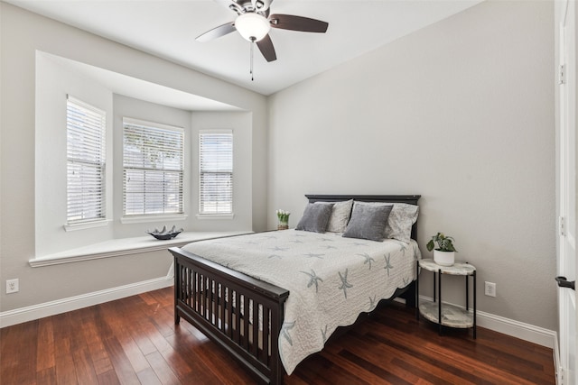 bedroom featuring baseboards, wood-type flooring, and ceiling fan