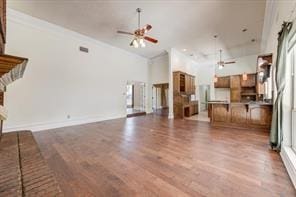 unfurnished living room with a ceiling fan and wood finished floors