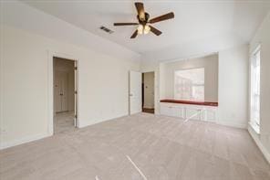 unfurnished room featuring visible vents and a ceiling fan