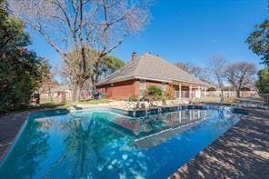 outdoor pool featuring fence