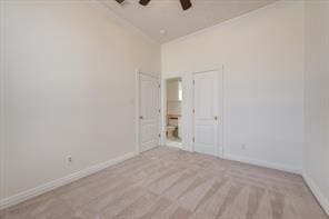 unfurnished bedroom with lofted ceiling, ceiling fan, baseboards, and a closet