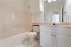 bathroom featuring toilet, tile patterned flooring, bathtub / shower combination, and vanity