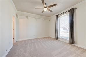 empty room featuring carpet, ceiling fan, and baseboards