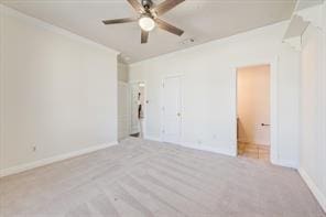 unfurnished bedroom featuring ceiling fan, baseboards, a closet, and ensuite bathroom