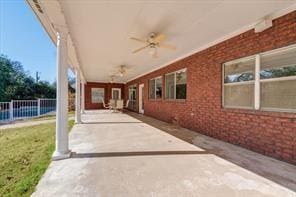 view of patio featuring fence and ceiling fan