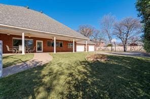 view of yard with a garage and a patio area