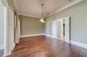 unfurnished dining area with ornamental molding, wood finished floors, and baseboards