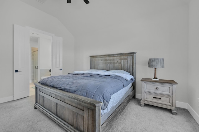 bedroom with light carpet, baseboards, a ceiling fan, ensuite bath, and vaulted ceiling