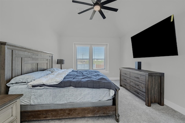 bedroom featuring baseboards, vaulted ceiling, a ceiling fan, and light colored carpet