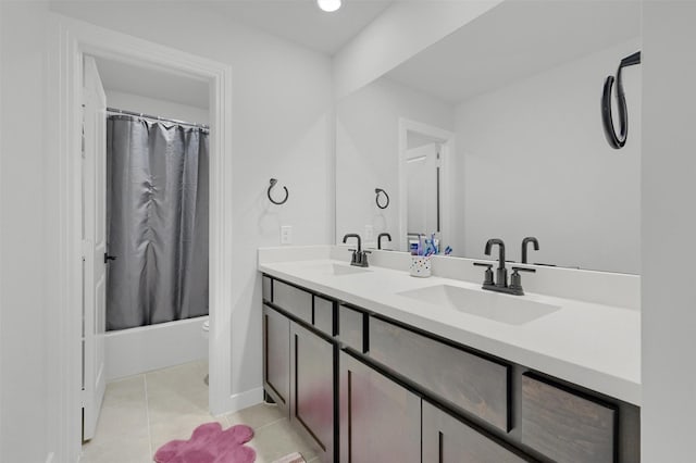 full bath featuring shower / bath combo, double vanity, a sink, and tile patterned floors