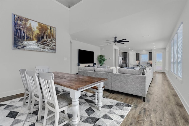 dining room with a ceiling fan, light wood-type flooring, baseboards, and recessed lighting