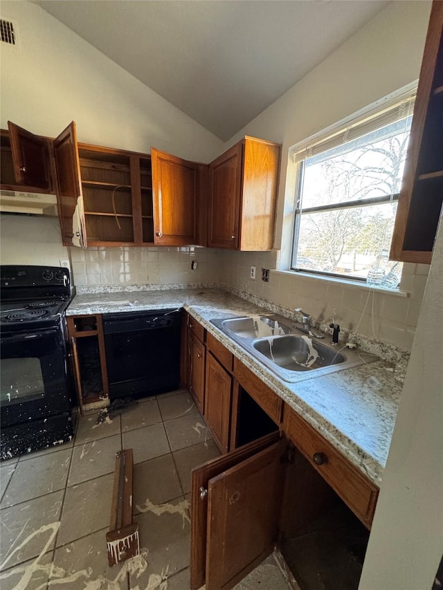 kitchen with lofted ceiling, under cabinet range hood, a sink, backsplash, and black appliances