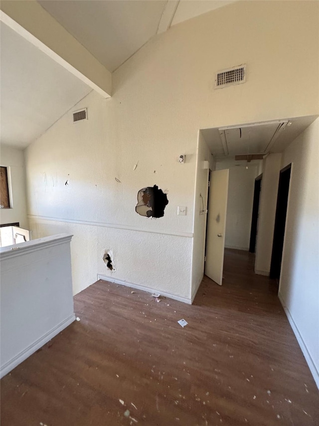 laundry area with wood finished floors, visible vents, and attic access