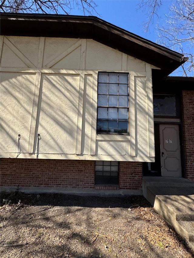 view of side of home featuring brick siding