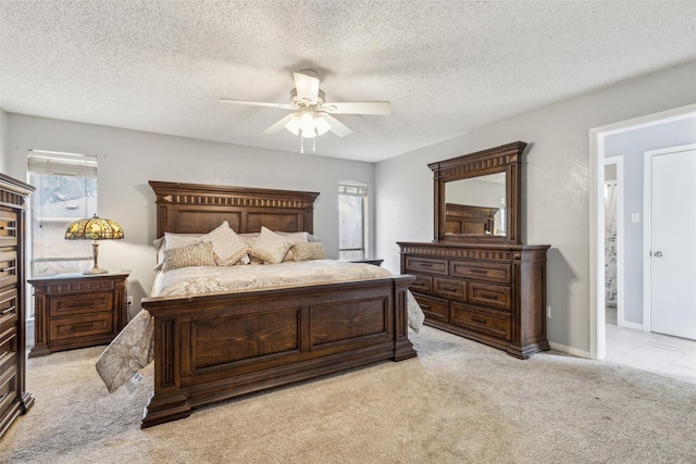 bedroom with a textured ceiling, baseboards, a ceiling fan, and light colored carpet