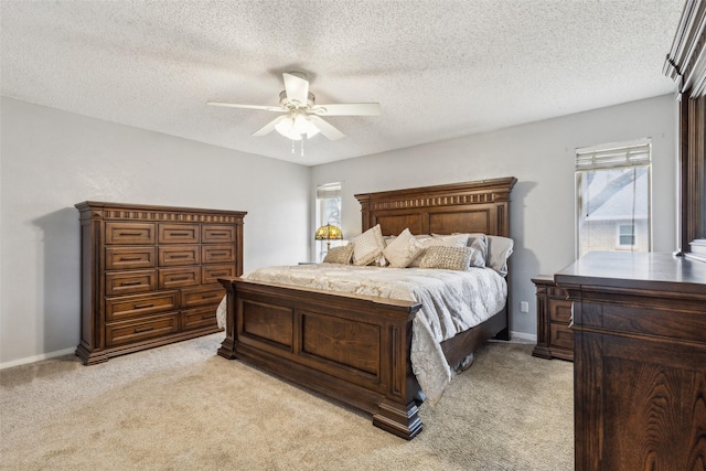 bedroom with ceiling fan, baseboards, and light colored carpet