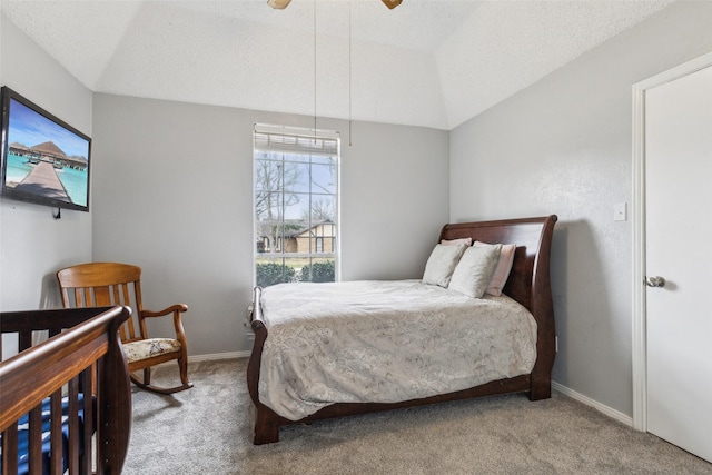 carpeted bedroom with vaulted ceiling, a textured ceiling, and baseboards