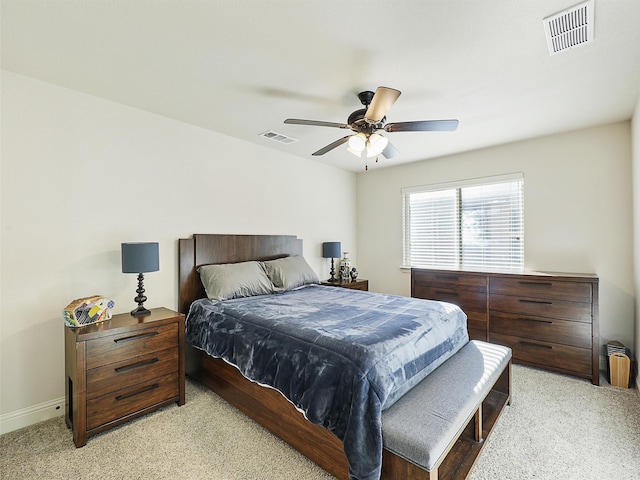 bedroom featuring a ceiling fan, light colored carpet, visible vents, and baseboards