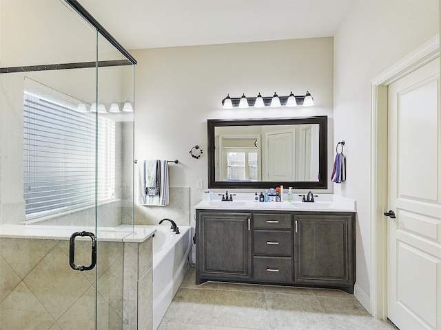 bathroom featuring double vanity, a sink, a shower stall, and a bath