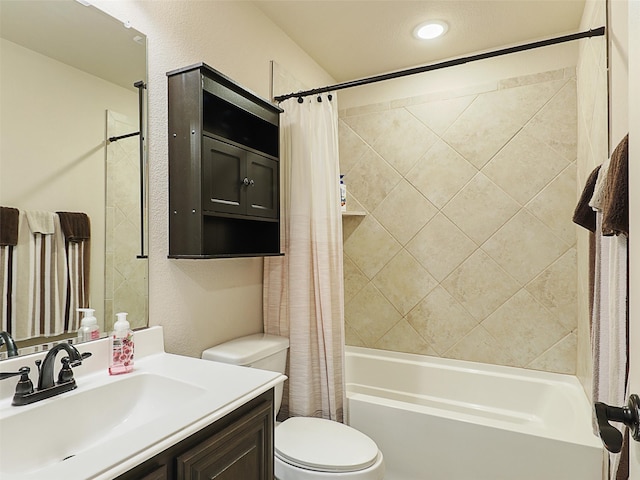 full bath with toilet, a textured wall, shower / bath combination with curtain, and vanity