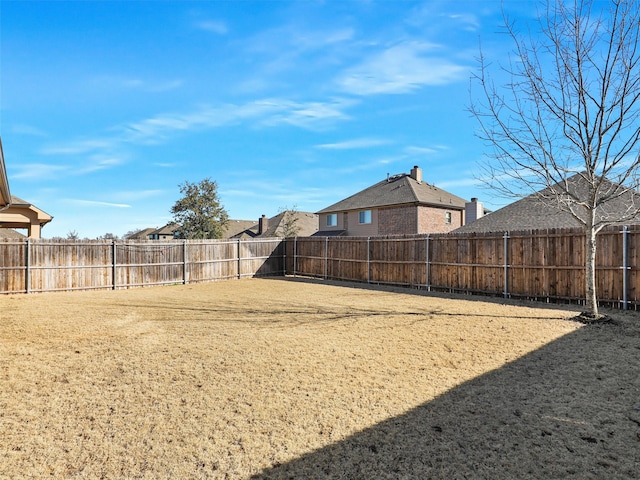 view of yard with a fenced backyard