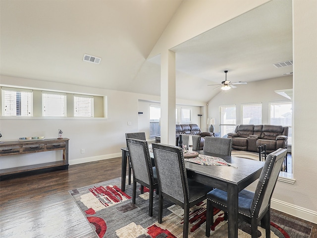 dining area featuring lofted ceiling, visible vents, baseboards, and wood finished floors