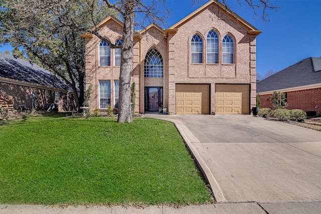 traditional home with an attached garage, a front yard, concrete driveway, and brick siding