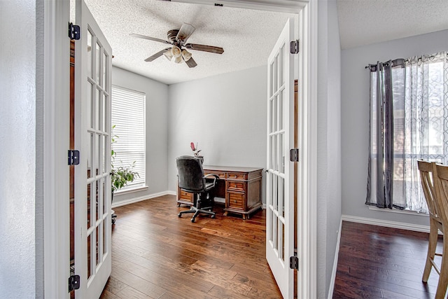 office space featuring baseboards, a ceiling fan, hardwood / wood-style flooring, a textured ceiling, and french doors