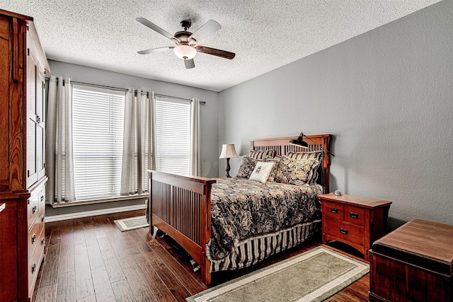 bedroom featuring dark wood-style flooring, a textured wall, and a textured ceiling