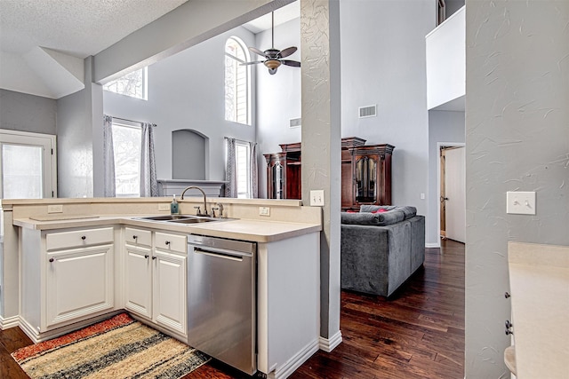 kitchen featuring dishwasher, dark wood finished floors, a sink, and open floor plan