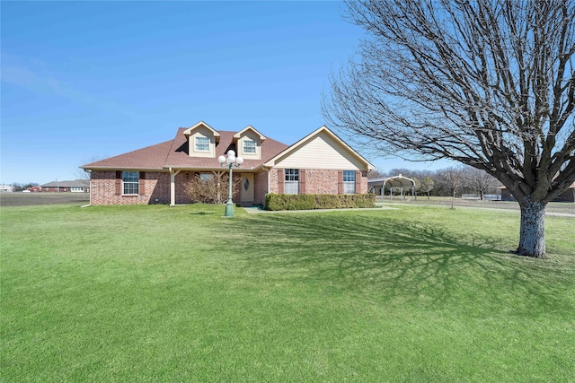 view of front of house featuring a front yard and brick siding