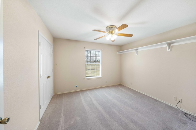 unfurnished room with light carpet, ceiling fan, and baseboards