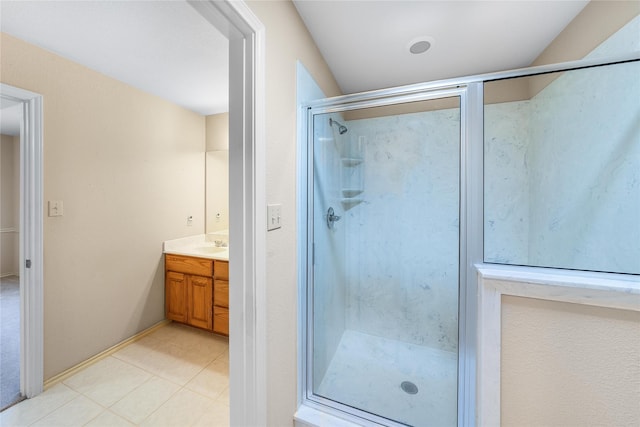 bathroom with tile patterned floors, a shower stall, and vanity