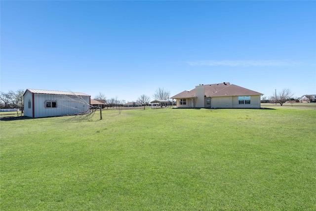 view of yard with a pole building and an outdoor structure