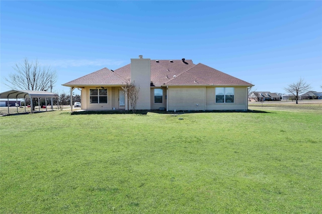 back of property featuring a yard, a carport, a chimney, and roof with shingles