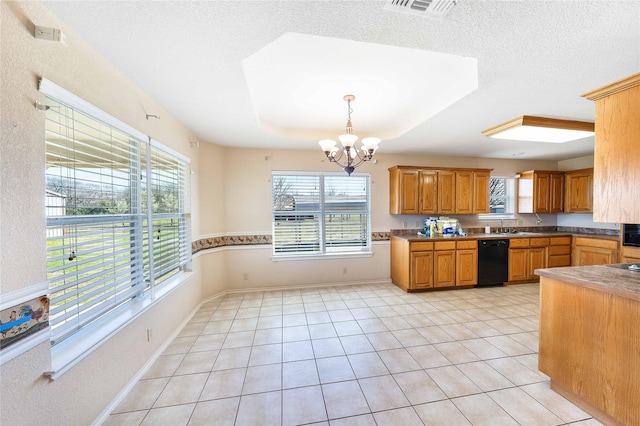 kitchen featuring light tile patterned floors, black dishwasher, a tray ceiling, a chandelier, and a sink