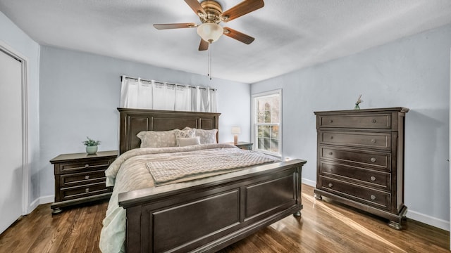 bedroom with baseboards, dark wood-type flooring, and ceiling fan