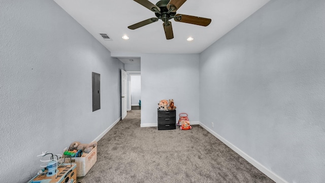 interior space featuring visible vents, baseboards, ceiling fan, carpet floors, and electric panel