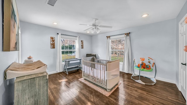 bedroom with recessed lighting, visible vents, baseboards, and wood finished floors