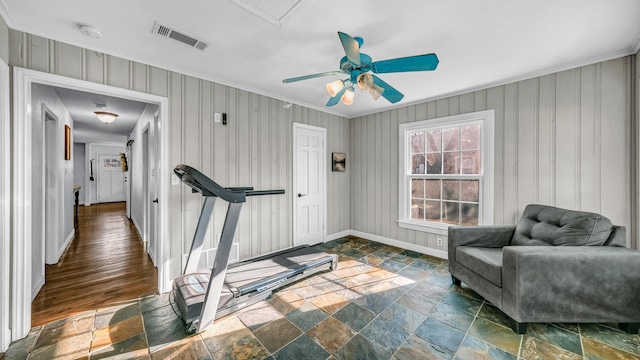 interior space with stone tile floors, visible vents, baseboards, and a ceiling fan