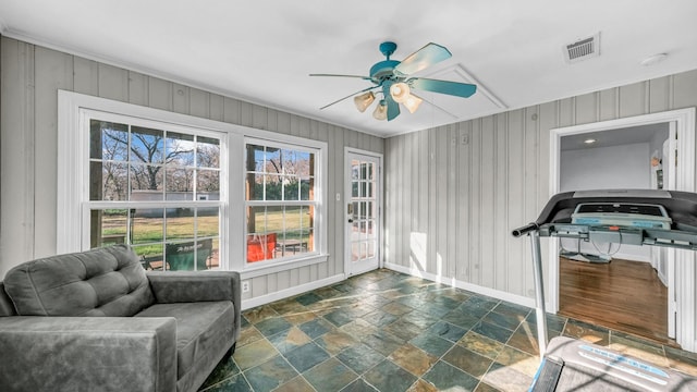 interior space featuring a wealth of natural light, visible vents, baseboards, and a ceiling fan