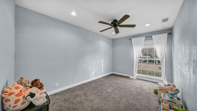 empty room featuring baseboards, visible vents, carpet floors, and ceiling fan