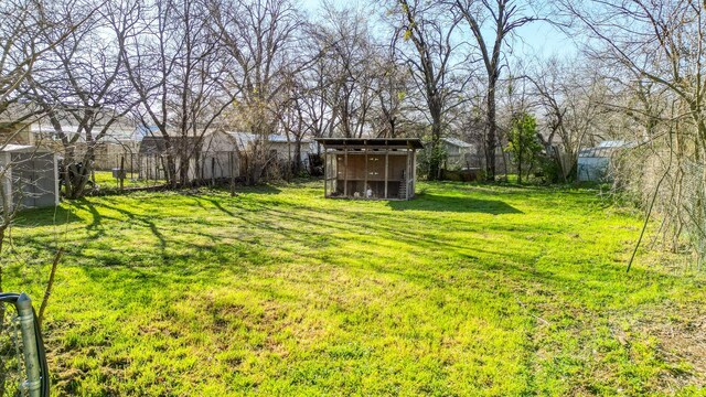 view of yard with an outbuilding, fence private yard, and a shed