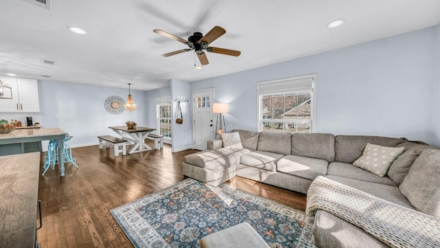 living area with recessed lighting, baseboards, a ceiling fan, and wood finished floors