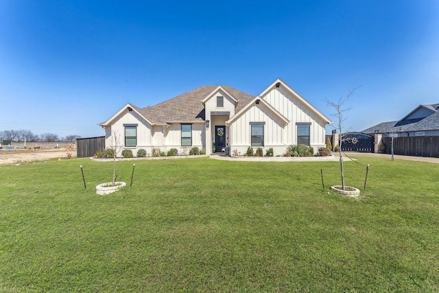 modern farmhouse featuring a front lawn, board and batten siding, and fence