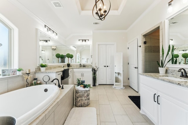 bathroom with a garden tub, a stall shower, a sink, and visible vents