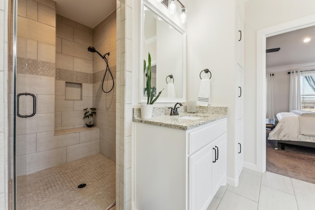 ensuite bathroom with ensuite bath, tile patterned flooring, a shower stall, and vanity