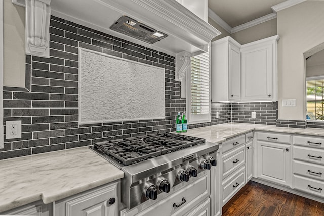 kitchen with backsplash, ornamental molding, stainless steel gas stovetop, dark wood-style floors, and white cabinetry